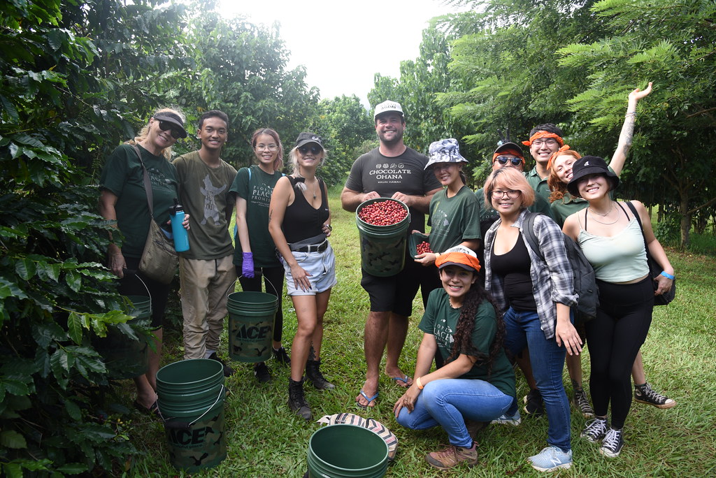 student club members group photo at farm with buckets of picked coffee berries